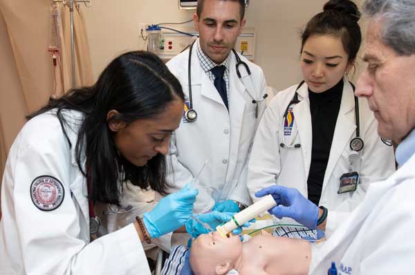 A student practices intubating a simulated pediatric patient.