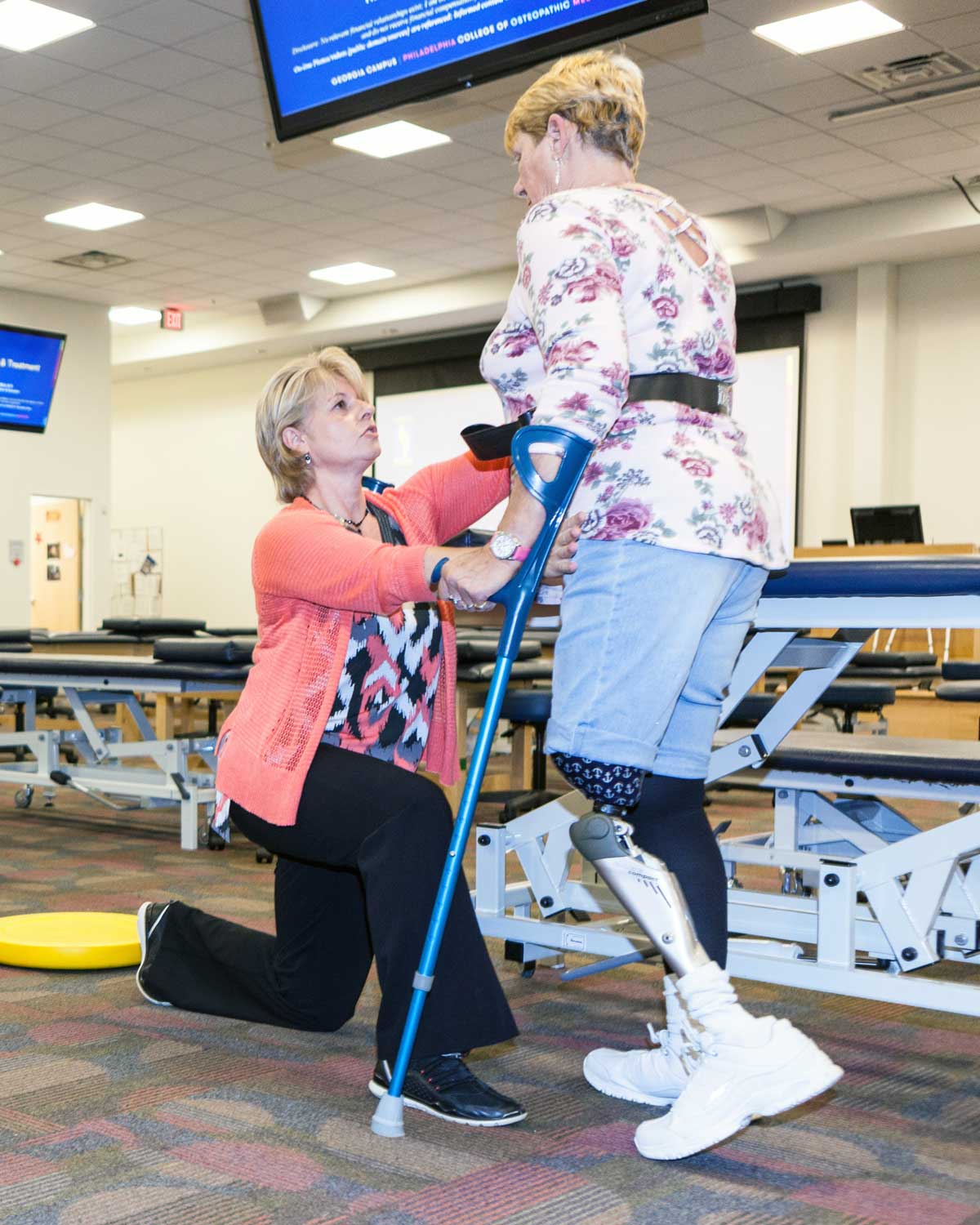A physical therapist helps a patient with exercises.