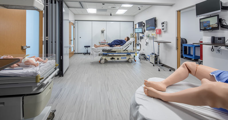 Mannequins, hospital beds and medical equipment in the birthing area of the Simulation Center