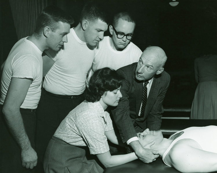 Students observe osteopathic manipulative medicine techniques during a 1960s classroom session.