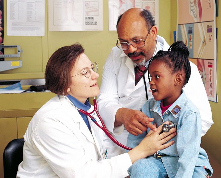 Oliver Bullock, DO '78, works with a medical student and a pediatric patient at the PCOM Healthcare Center - Cambria Division.