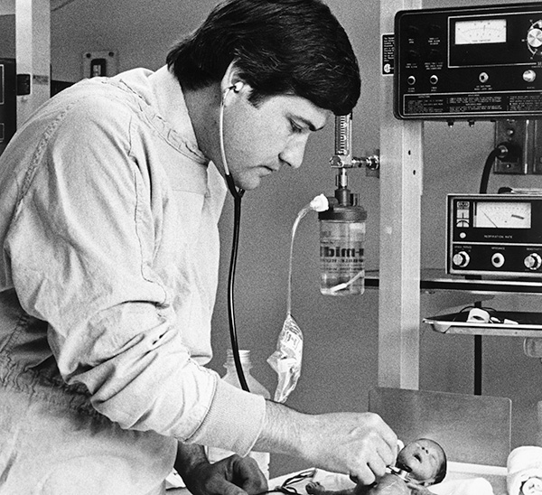Joseph Dieterle, DO '70, examining an infant pediatric patient.