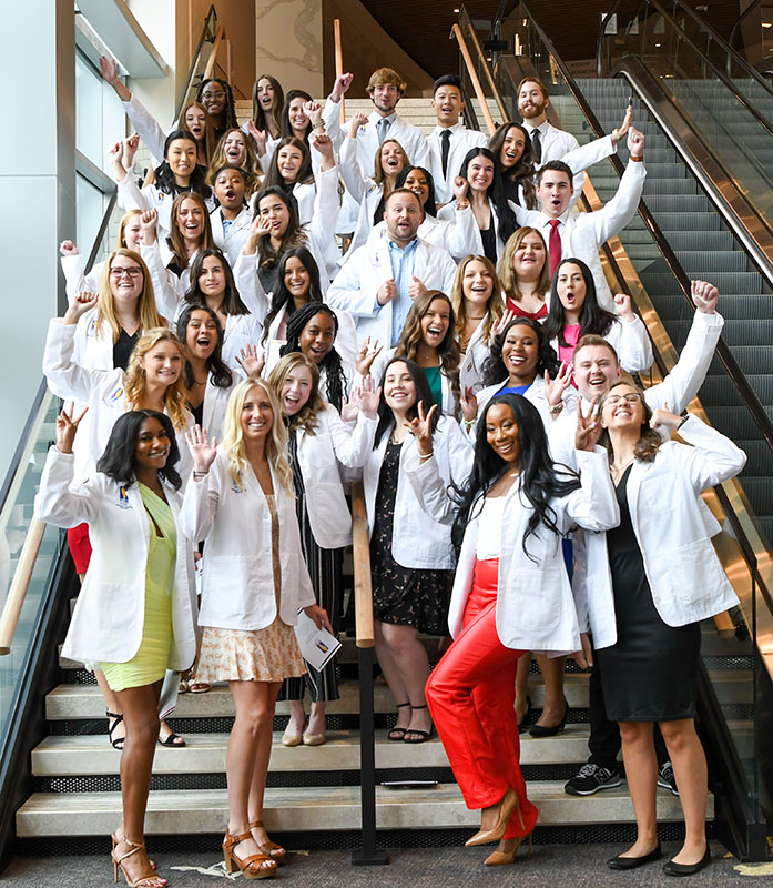 The DPT Class of 2024 cheer after their white coat ceremony at the Gas South District in Duluth, 2022.