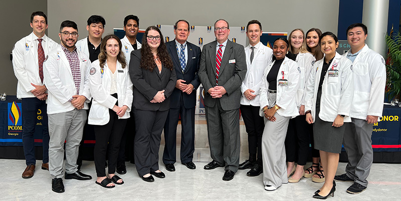 R. Bryan Ginn, Jr., (center left) has been PCOM Georgia's chief campus officers since 2012. Jeffrey K. Seiple (center right), is PCOM's Director of Anatomical Donor Services. They stand with med students after a body donor memorial service.