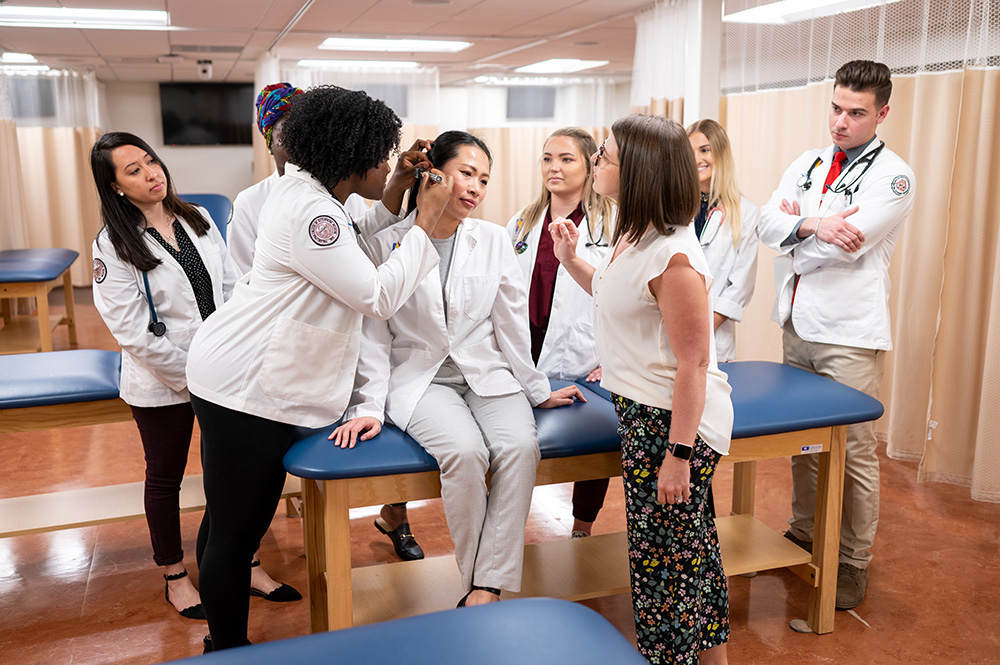 Physician assistant studies students learn from Lindsey Brown Caruther's, MS, PA-C, instruction during a 2022 class.