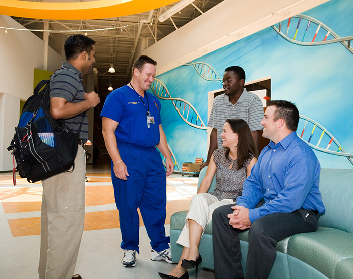 PCOM Georgia students and faculty talk in a lobby area (2006).