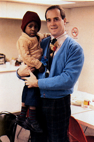 John R. Gimpel, DO '88, smiles with a young patient (early 1990s).
