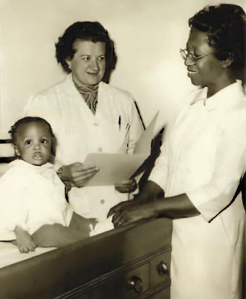 Director of Clinics Eleanor Masterson, DO '57, (left) and Chief Nurse Rosale Clark, RN, (right) examine a young patient, circa 1974.