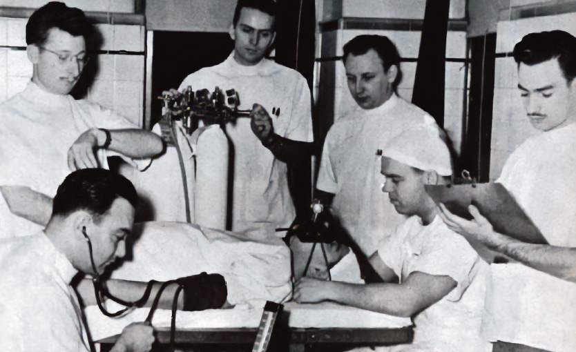 Junior year medical student assist an intern with administering anesthesia, circa 1942.