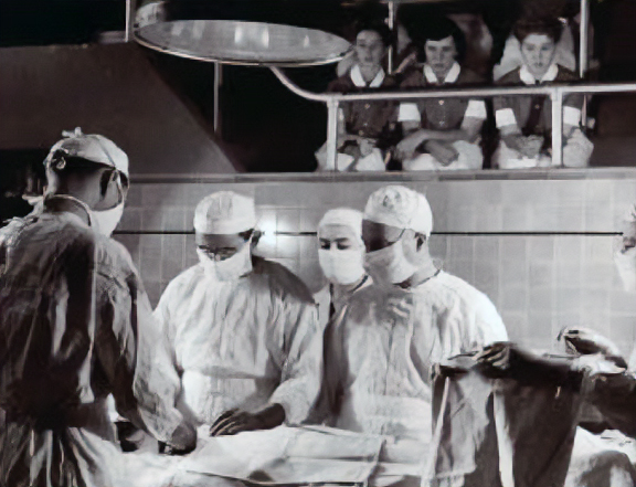 Student nurses observe a procedure in a surgical amphitheater in the 1950s.