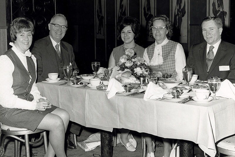 Former PCOM president Dr. Sherwood Mercer (second from left) enjoys a meal with Dr. Robert W. England (far right) and other staff members.