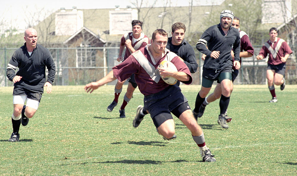 Kenneth Andrjko, DO '01, outmaneuvers opponents during a men's rugby team match.