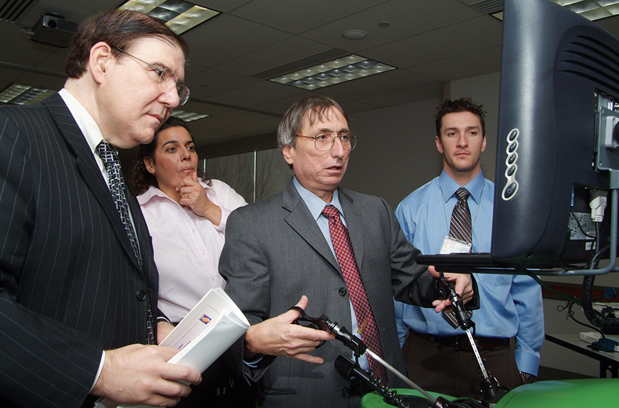 Chairman and Professor of Surgery Art Sesso, DO '84, demonstrates a robotic surgery simulation (2004).