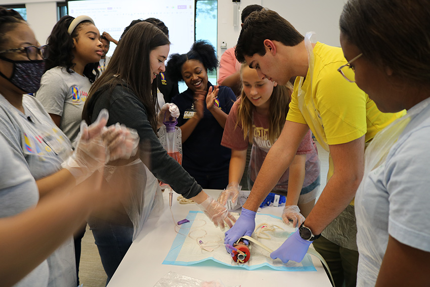 The Opportunities Academy is an annual summer STEM camp for local high schoolers held at the College's three locations. This photo shows med students working with youth during the 2022 camp at PCOM South Georgia in Moultrie.