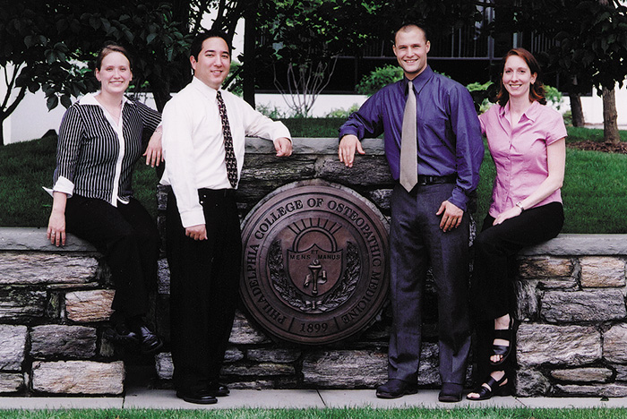 Osteopathic manipulative medicine (OMM) fellows pose on the Philadelphia campus with the College seal. Lauren Noto Bell, DO '06, is on the far right (late 2000s).