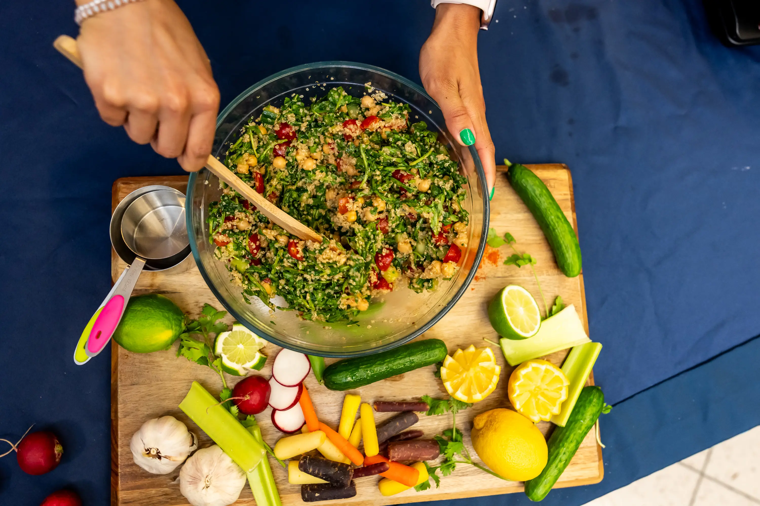 A DO student mixes ingredients in a glass bowl.