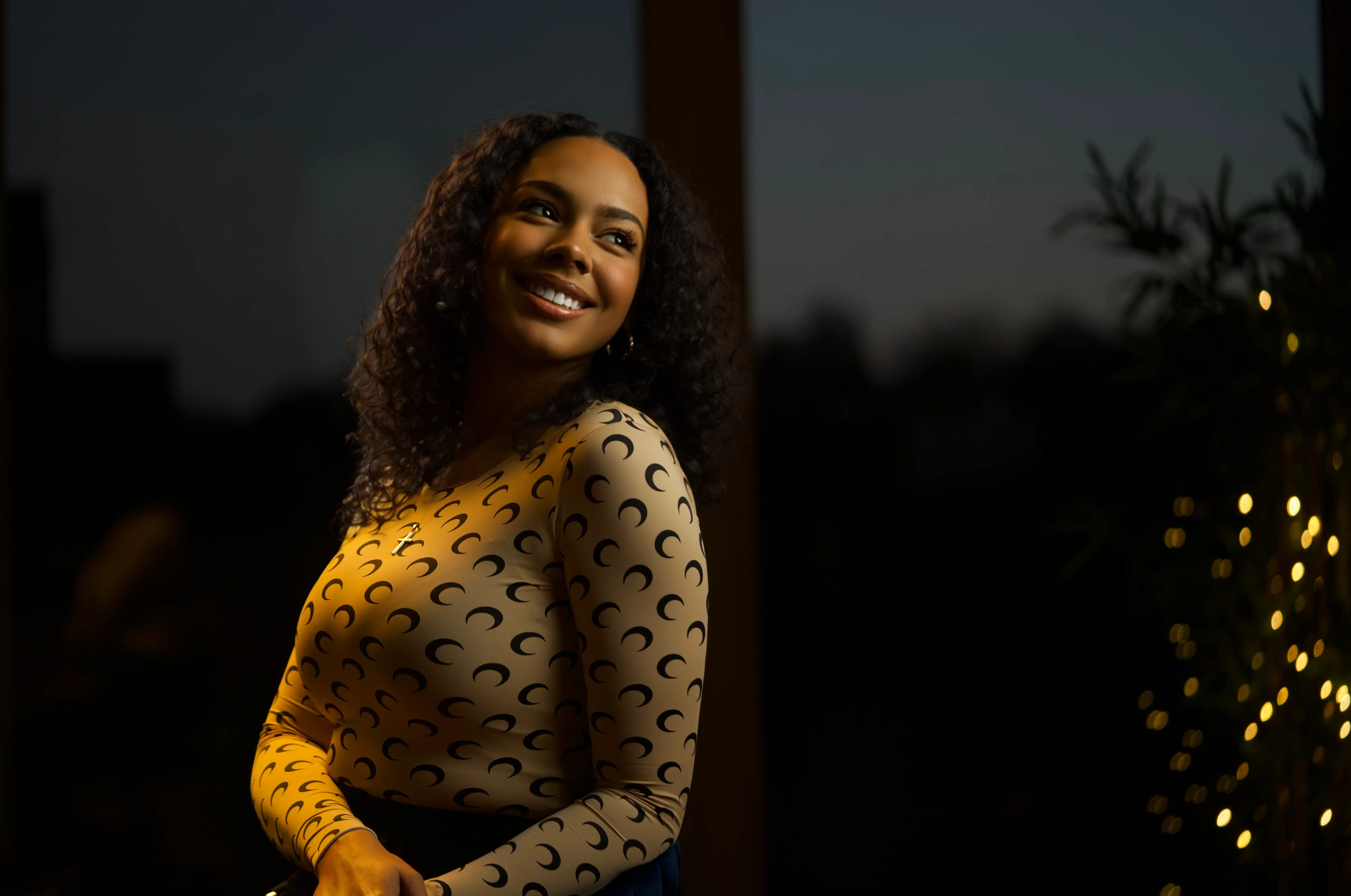 Brielle White posing against a dark background.