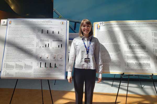 Anna Staskiewicz, MS/Biomed ‘22, a student of Dr. Xinyu (Eric) Wang, PhD, is shown standing in front of her poster presentation  at Research Day.