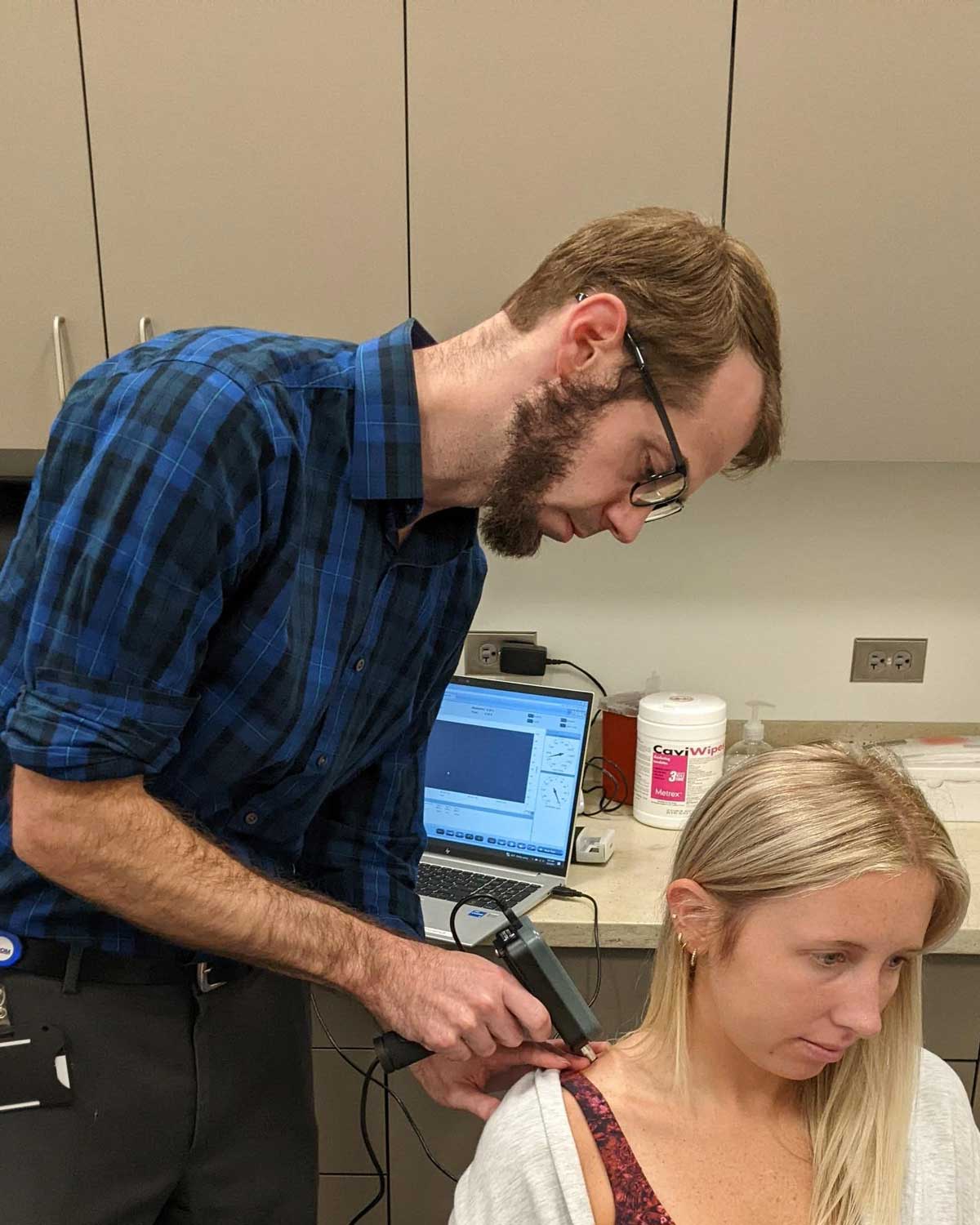 Scott W. Lowe, PT, DPT, OCS, FAAOMPT, works with a patient.