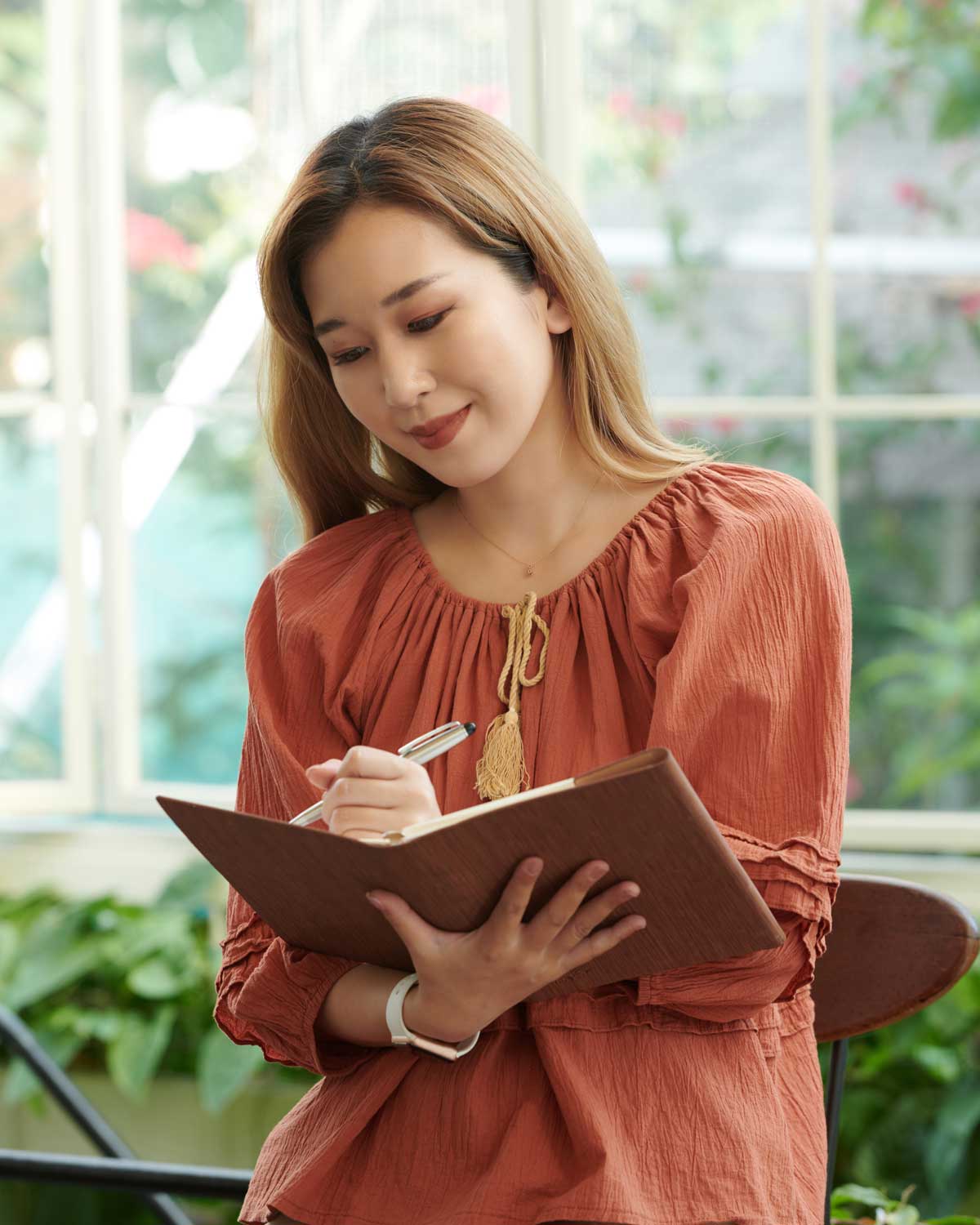 A woman writing in a journal.