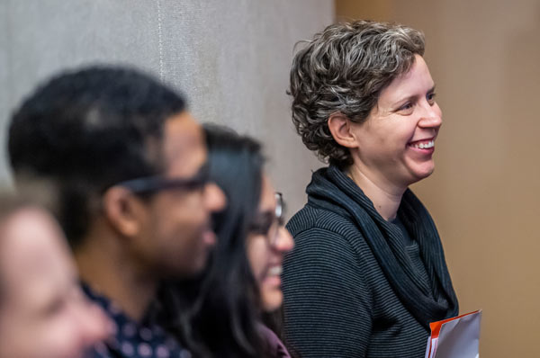 Psychology students smile during classroom lecture