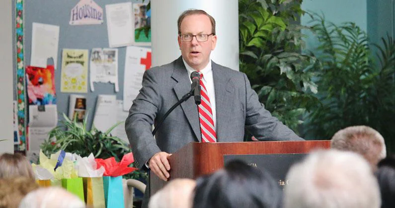 Jeffrey K. Seiple stands at a podium addressing the guests.