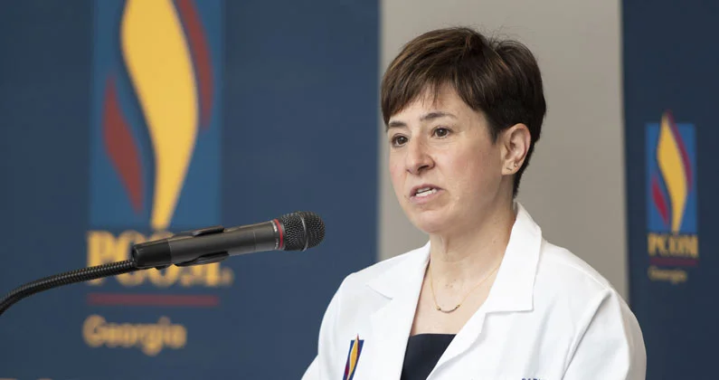 A close up photo of Dr. Andrea Mann addressing the audience