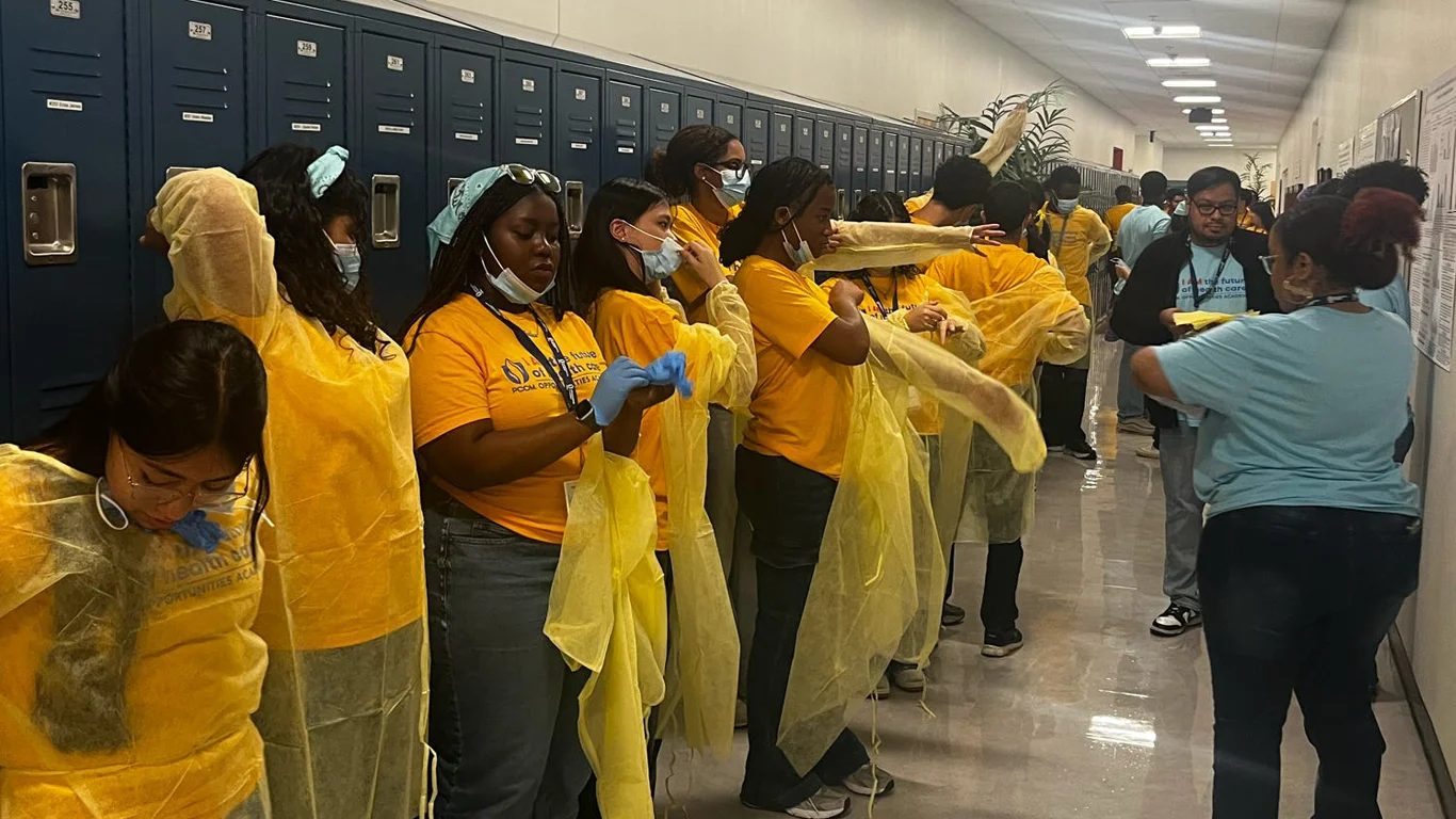 Opportunities Academy participants put on yellow scrubs