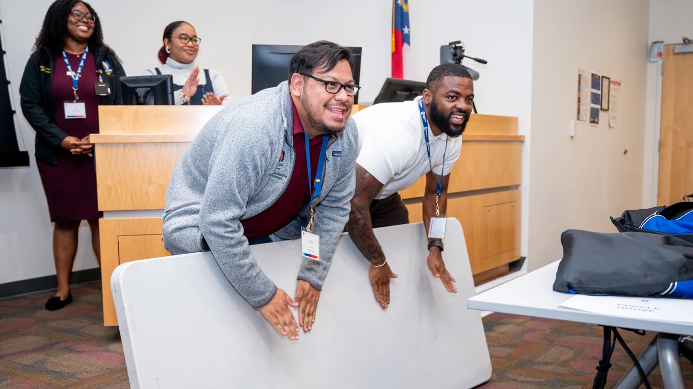 Opportunities Academy instructors drum on table