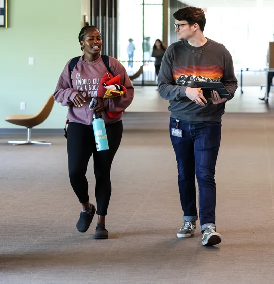 Graduate students at PCOM South Georgia in Moultrie walking and talking in a hallway