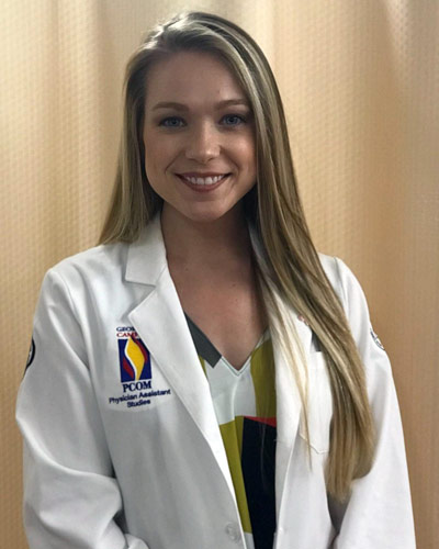 Hunter Dennard Richman, MS/PA '19, smiles in her physician assistant white coat.