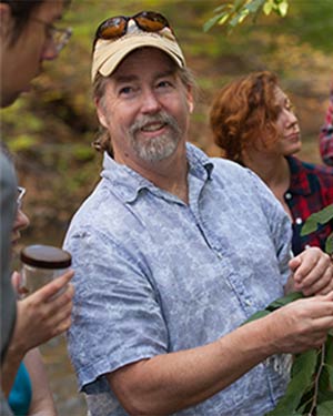 Photo of John Wallace, PhD teaching students outside