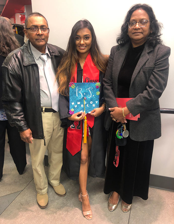 Anasha Kawall, MS, wears her cap and gown and smiles with her parents at PCOM Georgia's biomed graduation