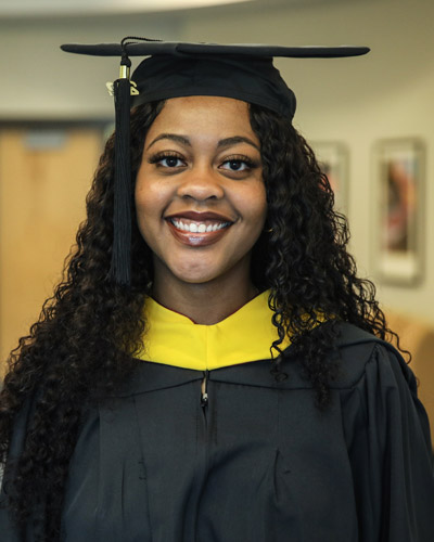 PCOM South Georgia biomedical sciences graduate Fiancee Williams, MS, wearing a cap and gown