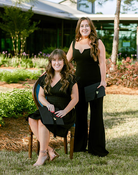 Anna Beth (seated) and Sarah Kate Boyette are twin sisters graduating from PCOM South Georgia.
