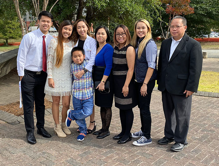 Julie Lu and her family outside of the PharmD white coat ceremony