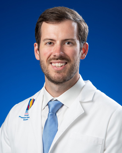 Professional headshot photo of PA Studies graduate Ryan Crane wearing his white coat