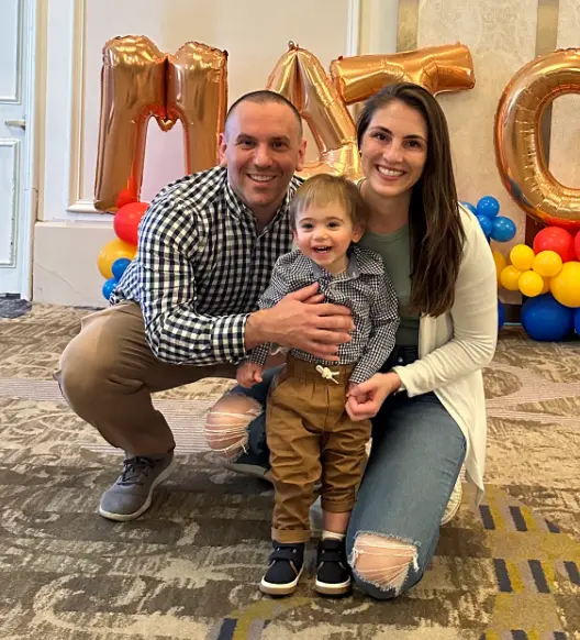 Eric Boxer and his wife and child smile during PCOM's Match Day 2024 event.