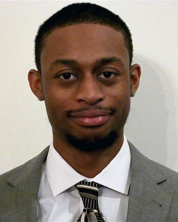 Professional headshot photograph of PCOM biomedical sciences graduate Kristofer James wearing a suit and tie