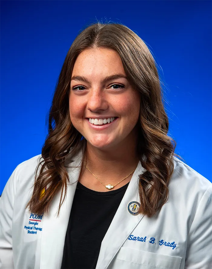 Professional headshot photo of PCOM Georgia physical therapy program graduate Sarah Grady, DPT '25, wearing her physican white coat