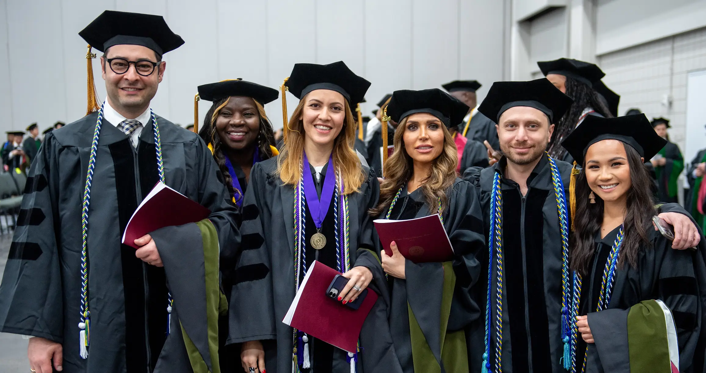 Six PCOM Georgia graduates posing at the Commencement ceremony.