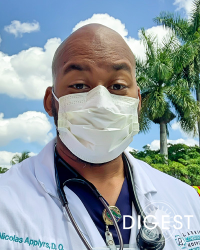 Headshot photograph of Nicolas Applyrs Jr., DO ’19, wearing his physician white and a face mask.