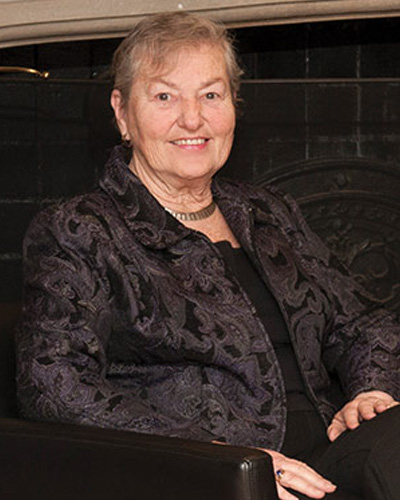 Lavinia “Vinnie” Lafferty smiling while sitting on a seat in the Levin Administration Building