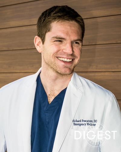 Richard M. Pescatore, II, DO ’14, FAAEM, smiling and wearing his physician white coat.
