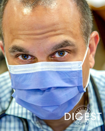 Suraj Kumar Saggar, DO ’02, dons a face mask and looks at the camera