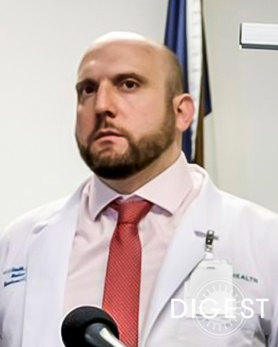 Headshot photograph of Jason A. Smith, DO ’08, wearing his stethoscope and physician white coat.