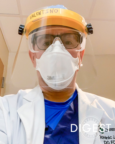 Dominic Valentino III, DO ’01, FCCP, FACOI, wearing PPE in a hospital