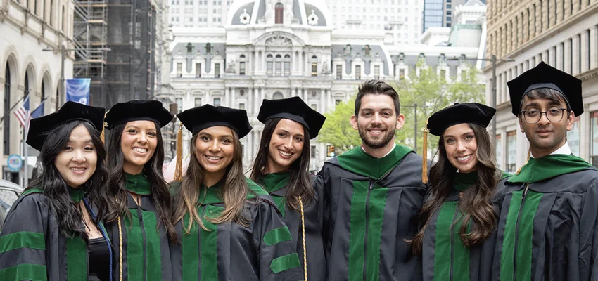 PCOM graduates pose along street in downtown Philadelphia