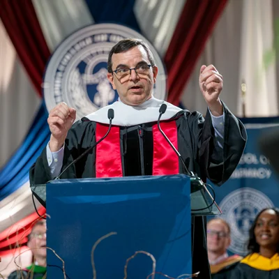J.D. Polk, DO, speaks at the podium during the PCOM Georgia Commencement Ceremony