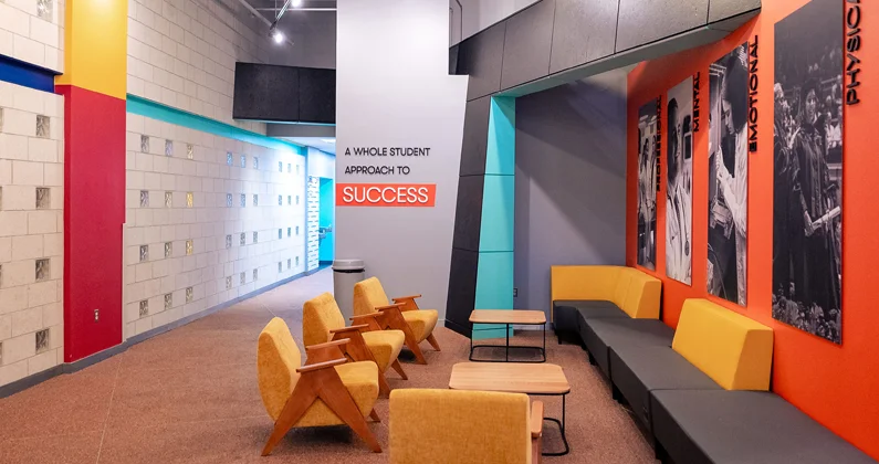 Lobby of PCOM Student Success Center featuring bright yellows, oranges and blue accents